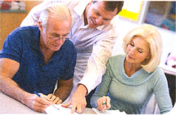 Three people looking at a paper